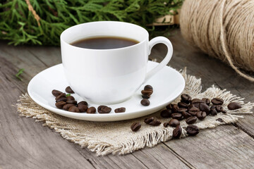 White cup of coffee with roasted coffee beans