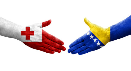Handshake between Bosnia and Tonga flags painted on hands, isolated transparent image.