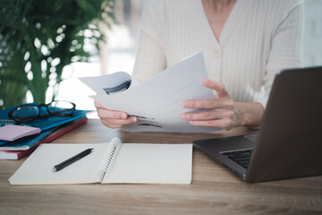 Close up woman hand hold worksheet.