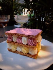 Mille-feuille raspberry chantilly dessert on a white plate