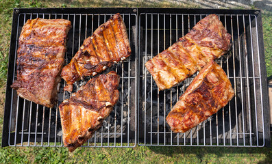 Roasted Juicy spare ribs cooked over the coals on a barbecue. Summer and holiday time. Delicious food