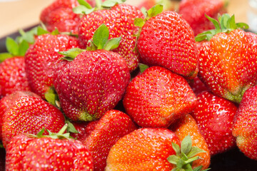 Ripe red strawberries in a plate close-up