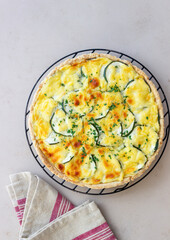 Pie with zucchini, cheese and herbs. Quiche. Vegetarian food. Healthy eating.