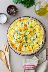 Pie with zucchini, cheese and herbs. Quiche. Vegetarian food. Healthy eating.
