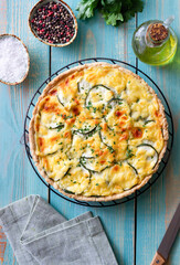 Pie with zucchini, cheese and herbs. Quiche. Vegetarian food. Healthy eating.