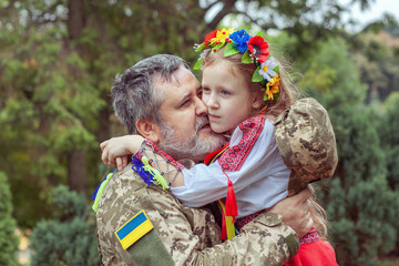 Portrait of a Ukrainian soldier with his little daughter.