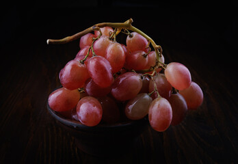 Bunch of ripe red grapes. Beautiful grapes on a dark background.