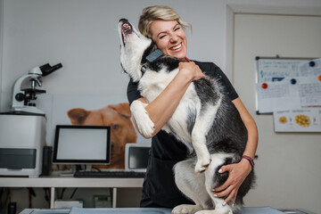 Portrait of woman vet and her professional occupation in modern veterinary hospital.