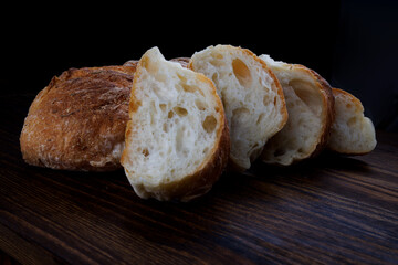 Sliced fresh baguette on a wooden table. Art bread.