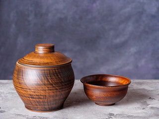 Clay pot and bowl on a rustic background