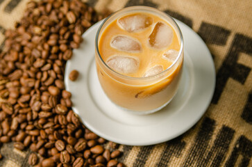 iced coffee on a table with roasted coffee beans