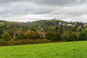 Fototapeta na wymiar Syratalbrucke bridge and Barenstein hill with lookout tower in Plauen city in Germany