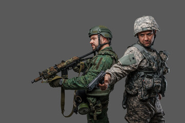 Portrait of nato and russian military men dressed in camouflage protective uniform.