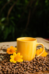 cup of coffee on a table with roasted coffee beans with a natural background