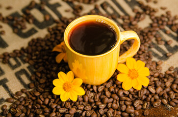 cup of coffee on a table with roasted coffee beans with a natural background