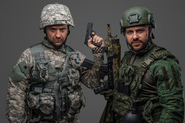 Portrait of military men dressed in camouflage protective uniform.