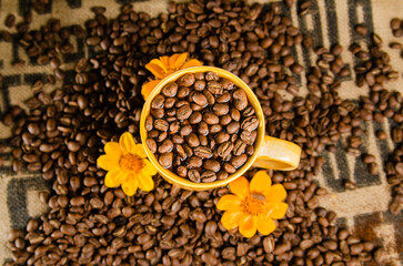 yellow coffee cup with coffee beans