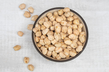 Chickpeas (garbanzo bean) in a ceramic bowl, isolated on white background, close up view