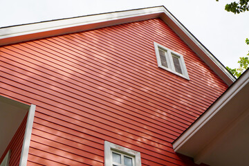 red decorative wooden wall panel of the house for outdoor ,selective focus on the wall