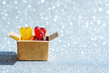 Two gummy bears in a small cardboard box