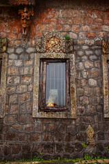Fototapeta na wymiar Ancient walls and window of Sampov Pram Pagoda in the Bokor National Park in Kampot, Cambodia