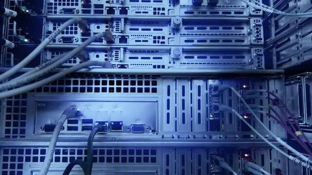 Close-up view of modern internet network switch Network dark server room with fiber optic hub.