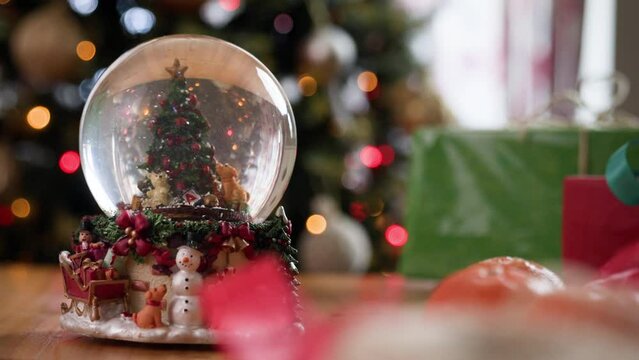 Christmas snowglobe with Christmas tree and snow falling inside 