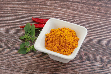 Yellow vibrant curcuma powder in the bowl
