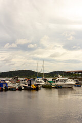 Fototapeta na wymiar Motor boats on pier on Ladoga lake