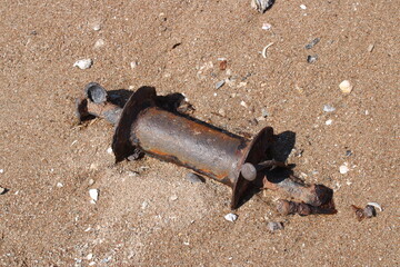 Antique maritime fire extinguisher on beach