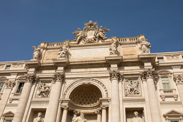 Obraz premium Trevi Fountain in Rome, Italy. Ancient fountain. Roman statues at piazza in old medieval city among traditional italian houses and street lamps. Famous landmark.