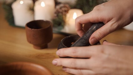 The top view of a pestle spices, peppers and sea salt in the grey stone mortar