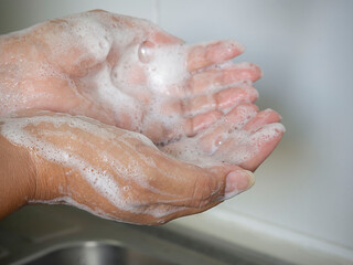 Corona virus pandemic prevention wash hands with soap warm water