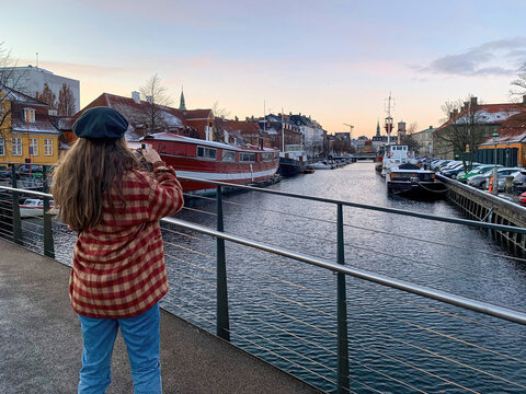 Young woman taking picture from a bridge in Copenhagen
