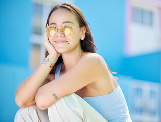 Fashion sunglasses, asian and woman relax in urban city street for peace, freedom or Singapore vacation. Portrait of happy gen z girl on holiday with chic clothes, retro and vintage yellow glasses