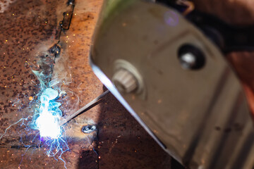 Worker wearing industrial uniforms and Welded Mask industrial safety first concept.