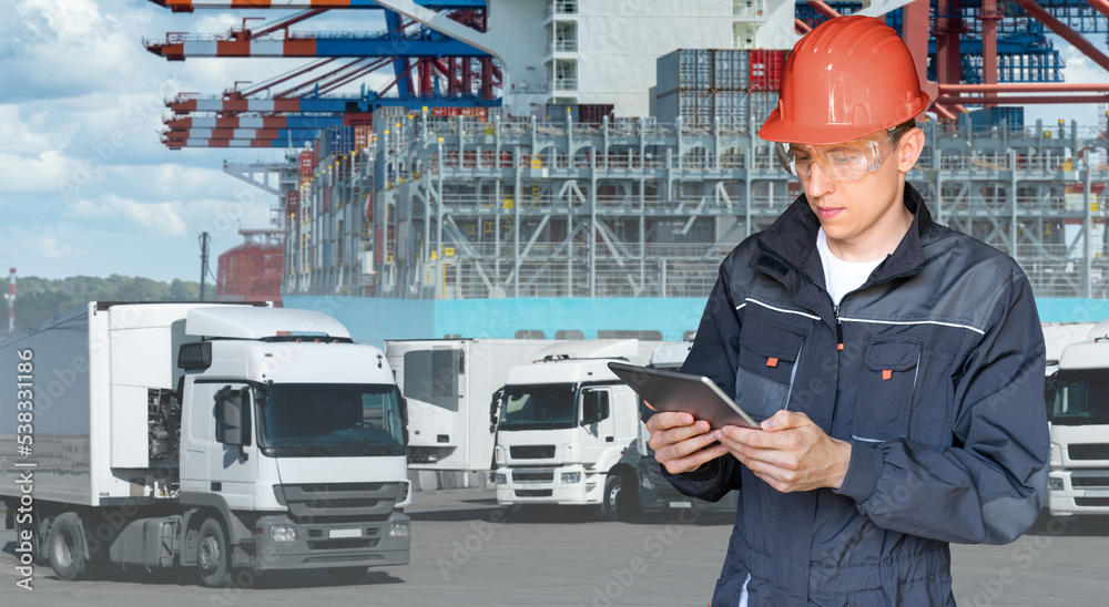 Poster port manager with a digital tablet against the background of a trucks and ship loaded with container