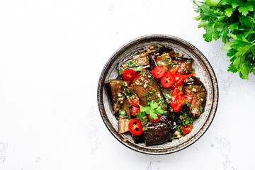 Grilled spicy eggplant with hot red chili peppers, soy sauce, garlic and sesame seeds in asian...