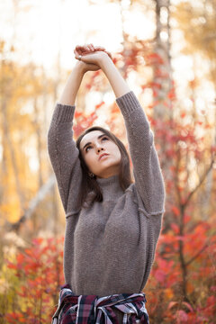 Attractive young woman posing in autumn forest