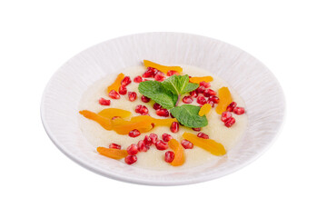 Plate of oatmeal with porridge , dried apricots and pomegranates