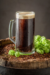Fresh and cold dark beer with hops and wheat