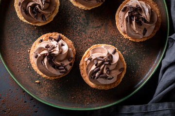 Delicious mini tartlets with chocolate cream and sprinkles.