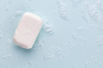Soap bar and foam on white background, top view. Mockup for design