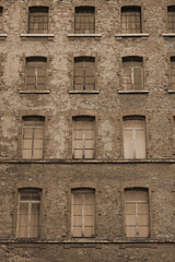 red bricks and old peeling windows of an old industrial building