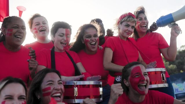 Multiracial red sport football fans celebrating with crowd cheering team on stadium tribune - Soccer spectators watching match game during world championship event