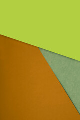 Dark and light, Plain and Textured Shades of yellow green brown papers background lines intersecting to form a triangle shape