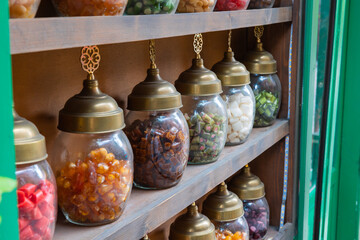 Jars of candies on the shelves of a candy store or shop