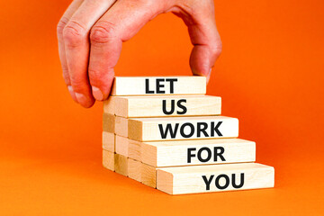 Let us work for you symbol. Concept words Let us work for you on wooden blocks. Businessman hand. Beautiful orange table orange background. Business and let us work for you concept. Copy space.