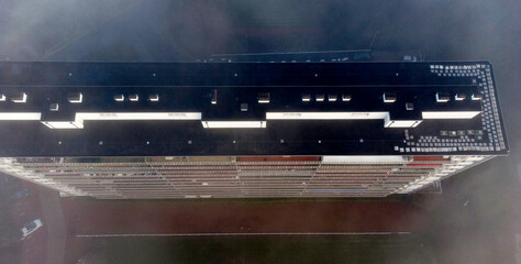 Aerial view of an apartment building, on a cold, foggy day © Catalin