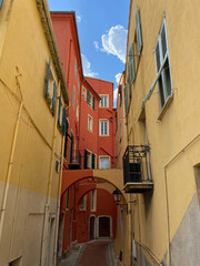 Fototapeta na wymiar Menton, France, October 6, 2021: The colorful facades of houses in the old heart of Menton, southern France, French Riviera.